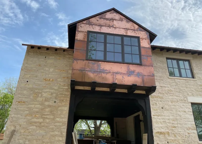 Copper metal panel facade on a stone building for Roof Repair in Anadarko
