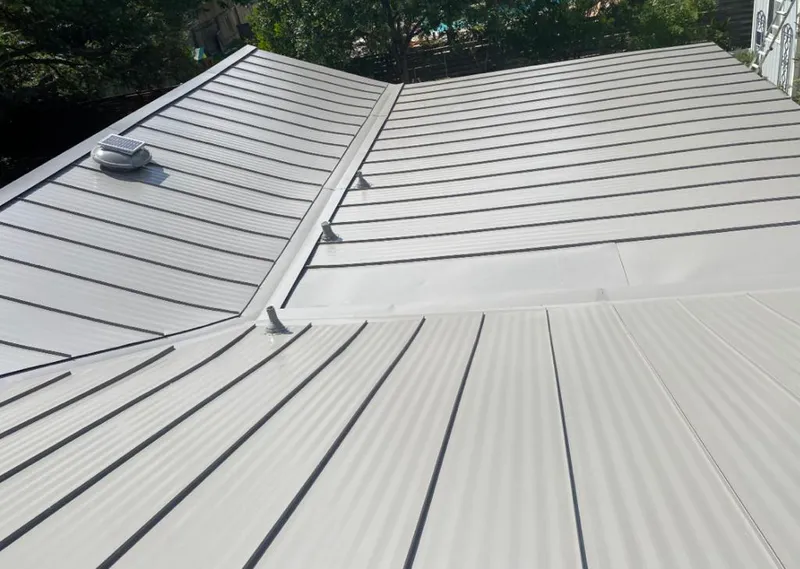 Solar attic fan installed on a metal roof for Roof Ventilation in Anadarko